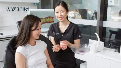 A dentist discusses Invisalign treatment with patient at Delight Dental Spa.